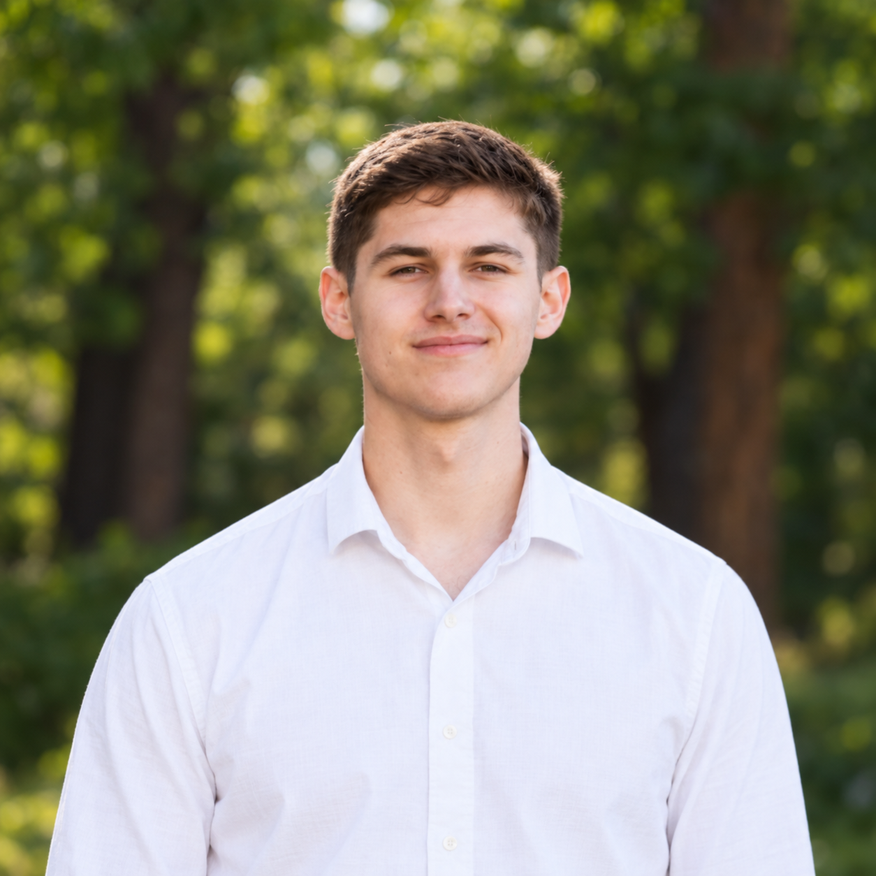 Portrait of Mihai Vlad in a white shirt outdoors